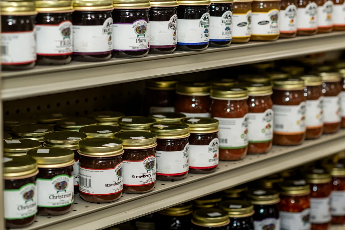 An assortment of jams and preserves on the pharmacy shelves
