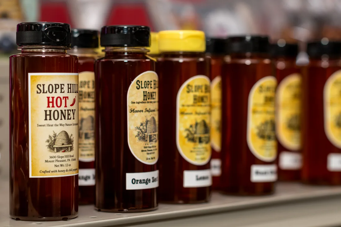 Bottles of Slope Hill honey, including hot honey and flavored varieties