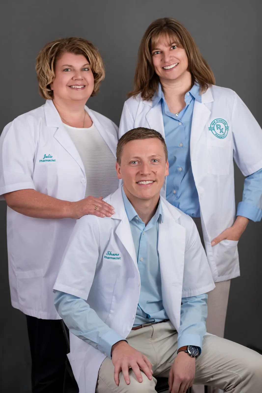 The three New Stanton Pharmacy pharmacists together in their white coats